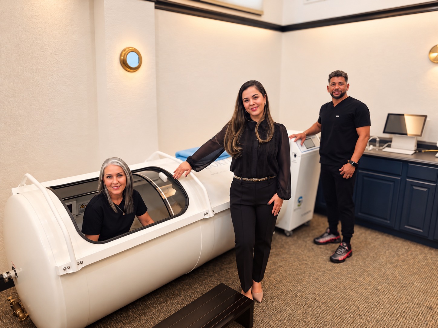 NeuroLift team beside a hyperbaric oxygen chamber